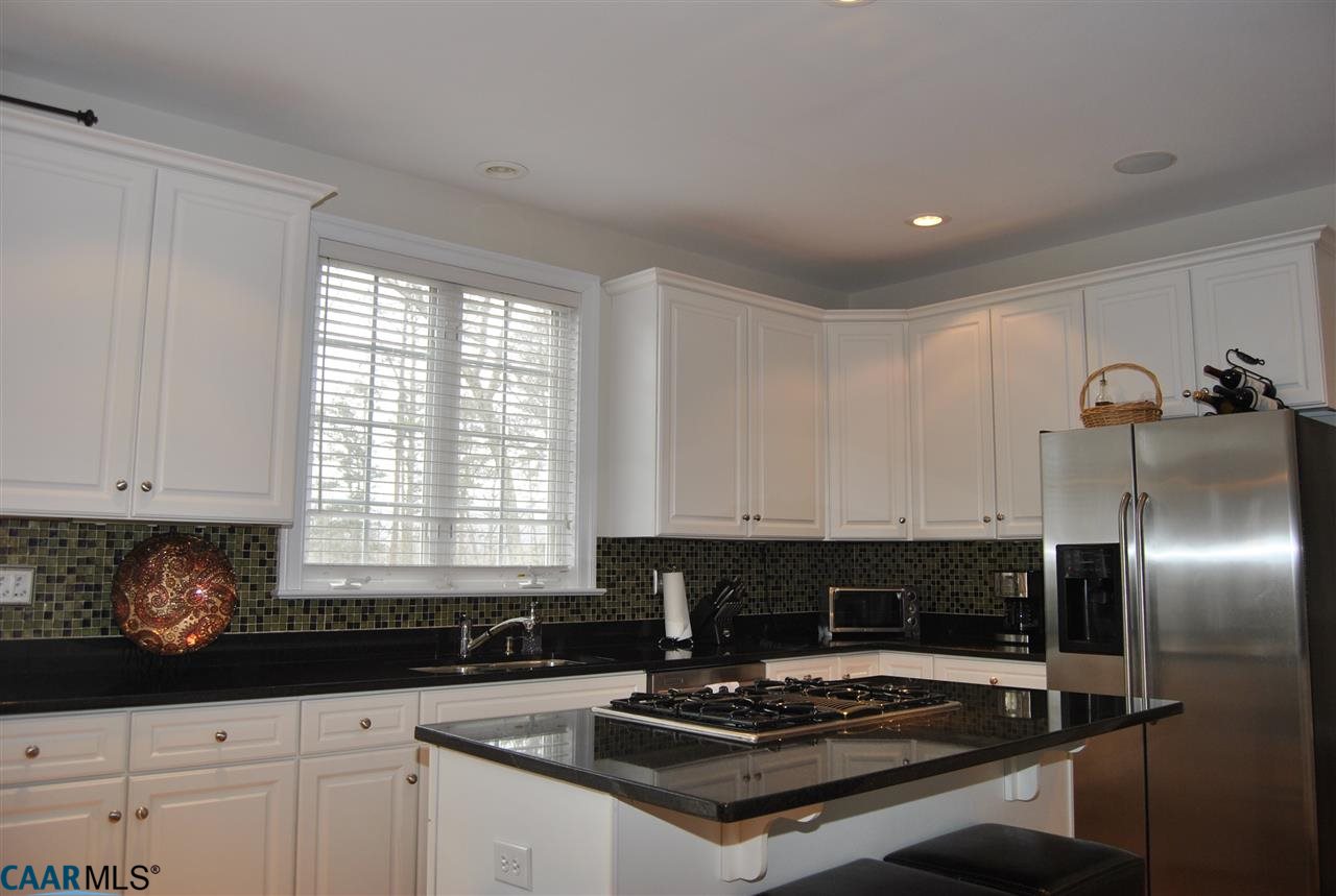 1860 Rhett Court Charlottesville, VA 22903 - Photo 15 of 39 a kitchen with granite countertop a stove a sink and a refrigerator
