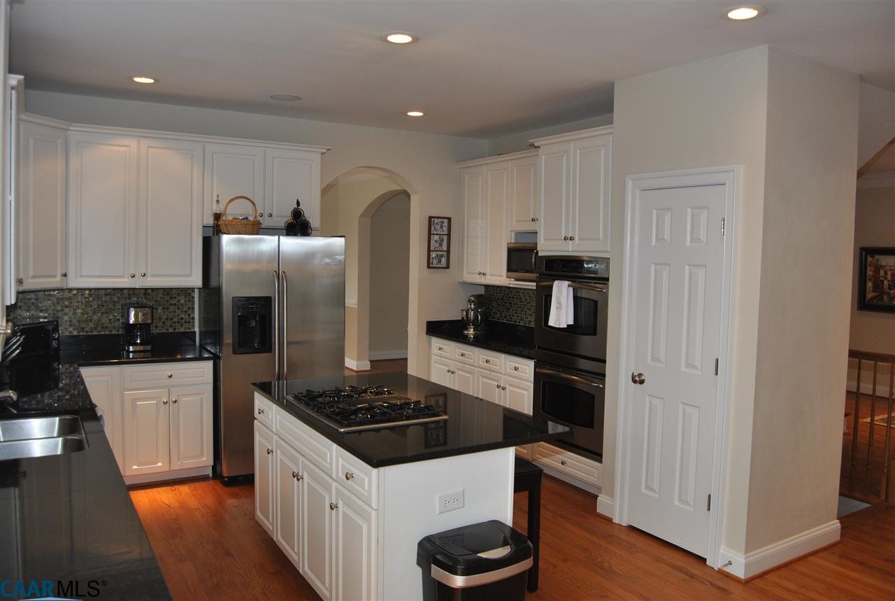 1860 Rhett Court Charlottesville, VA 22903 - Photo 16 of 39 a kitchen with stainless steel appliances a refrigerator a stove a sink and white cabinets