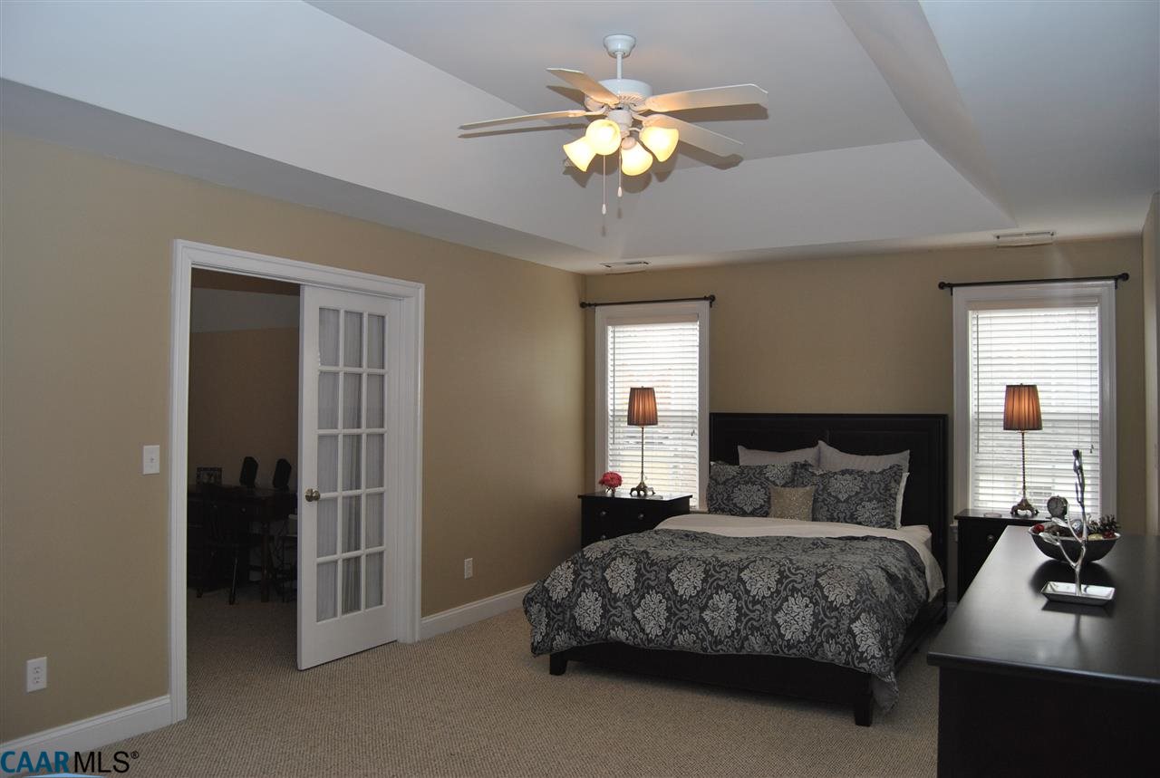 1860 Rhett Court Charlottesville, VA 22903 - Photo 23 of 39 a bedroom with a large bed and a chandelier