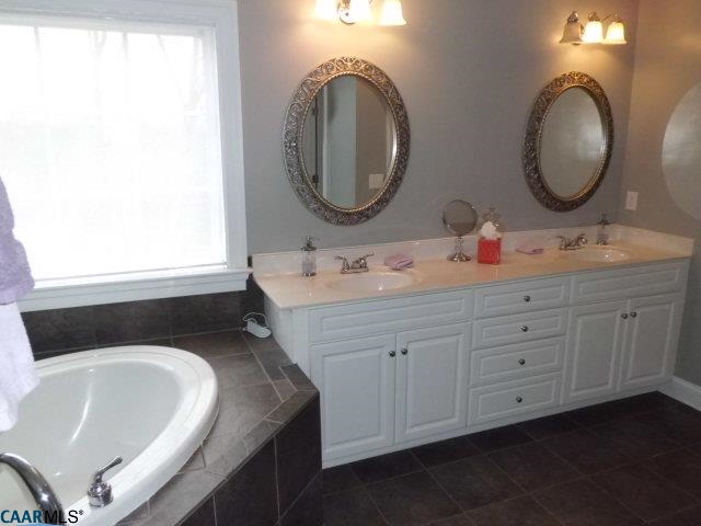 1860 Rhett Court Charlottesville, VA 22903 - Photo 29 of 39 a bathroom with a granite countertop double vanity sink and a mirror
