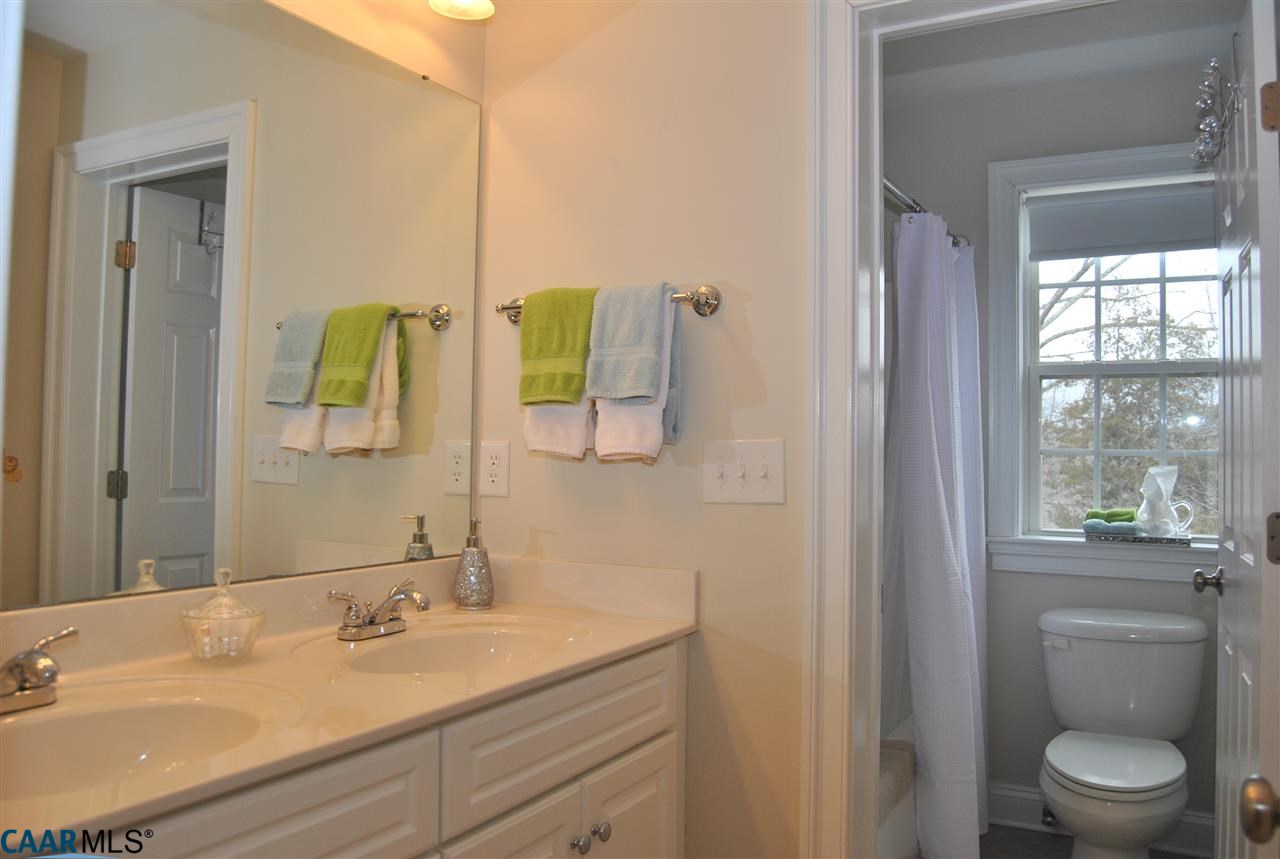 1860 Rhett Court Charlottesville, VA 22903 - Photo 32 of 39 a bathroom with a granite countertop sink a toilet and a mirror