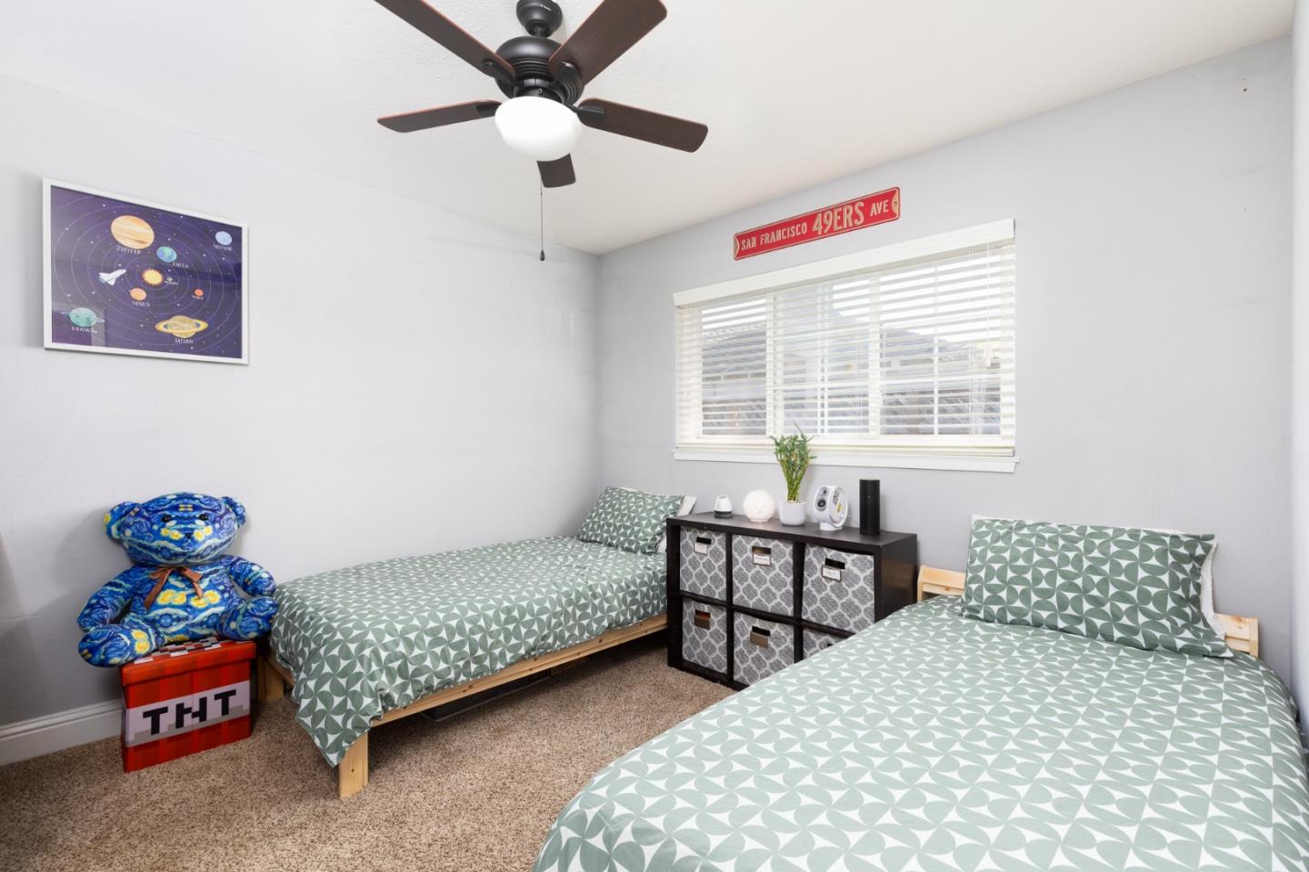 1446 Sharp Avenue Campbell, CA 95008 - Photo 16 of 22 a bedroom with a bed and a chandelier