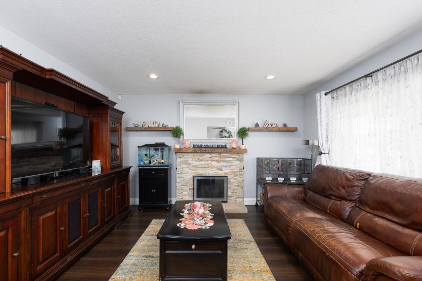 1446 Sharp Avenue Campbell, CA 95008 - Photo 2 of 22 a living room with furniture a flat screen tv and a fireplace