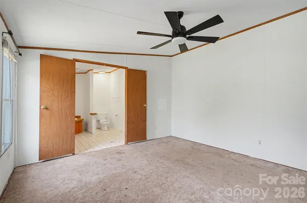 a view of a room with a ceiling fan and a wooden floor