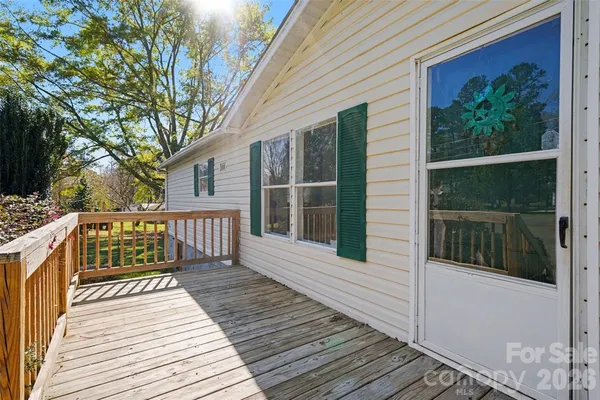 a balcony with wooden floor and fence
