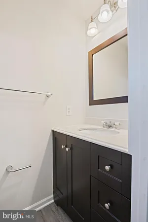 a bathroom with a sink a mirror and a toilet