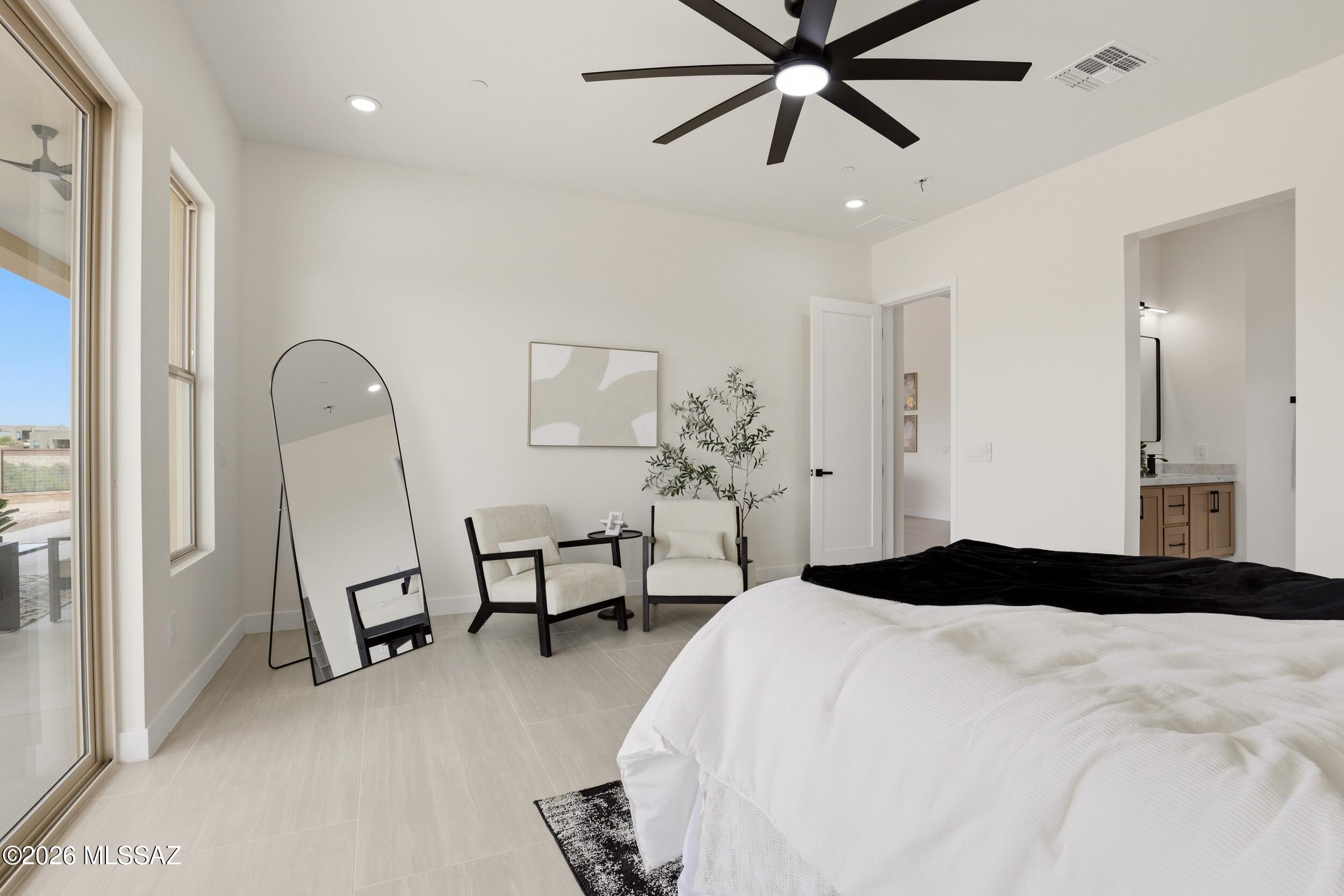 14527 East Sands Ranch Road Vail, AZ 85641 - Photo 23 of 48 a bedroom with a bed and a chandelier