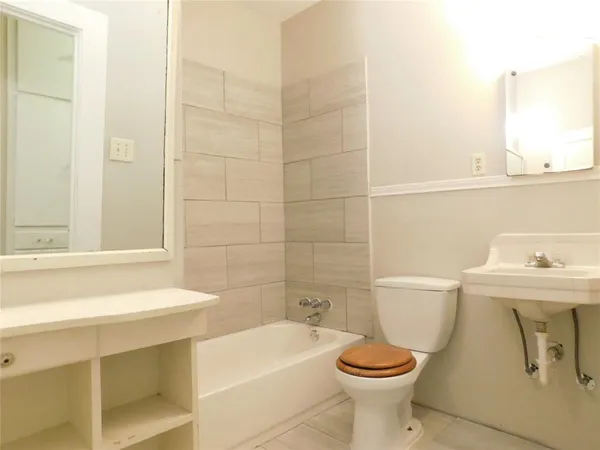 a bathroom with a sink a toilet and a bathtub