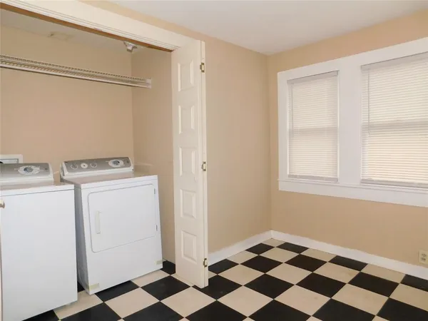 a view of a storage & utility room with a washing machine dryer and washer
