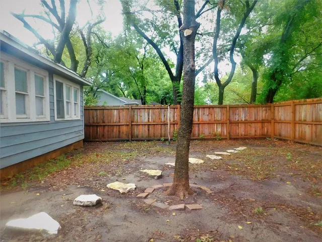 a backyard of a house with a tree