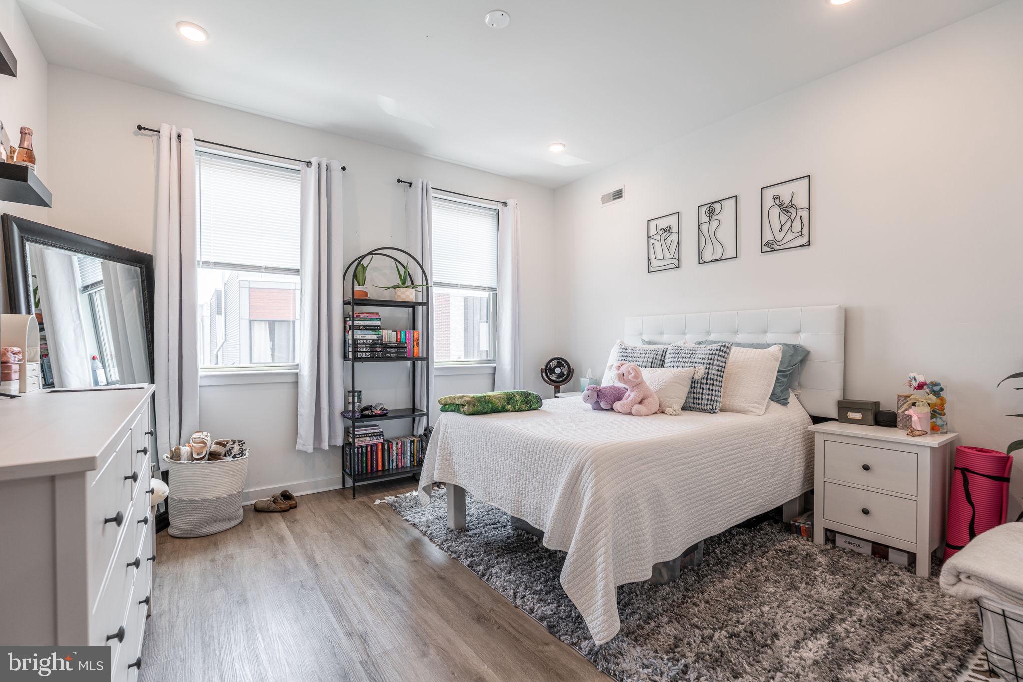 2613 Federal Street Philadelphia, PA 19146 - Photo 17 of 18 a bedroom with a bed and wooden floor