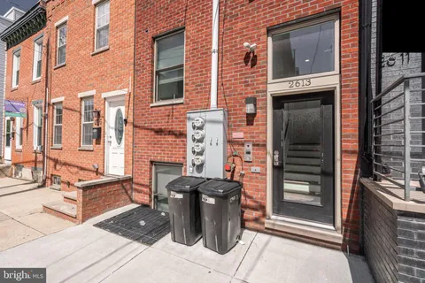 a view of a brick buildings with entryway doors