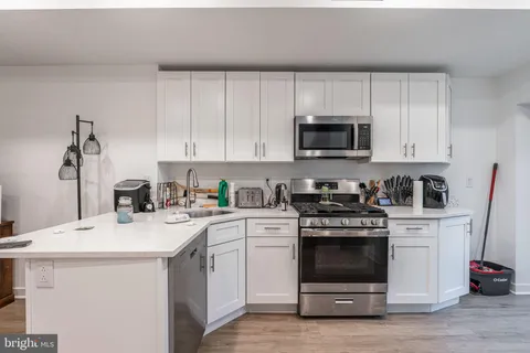 a kitchen with a sink stove and cabinets