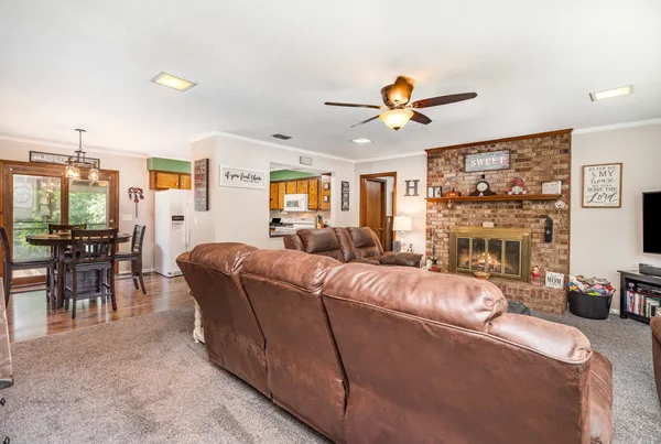 a living room with furniture a dining table and a fireplace