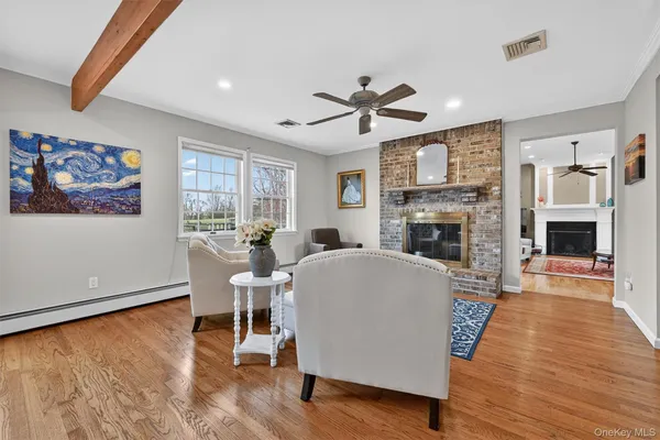 a living room with furniture wooden floor and a fireplace