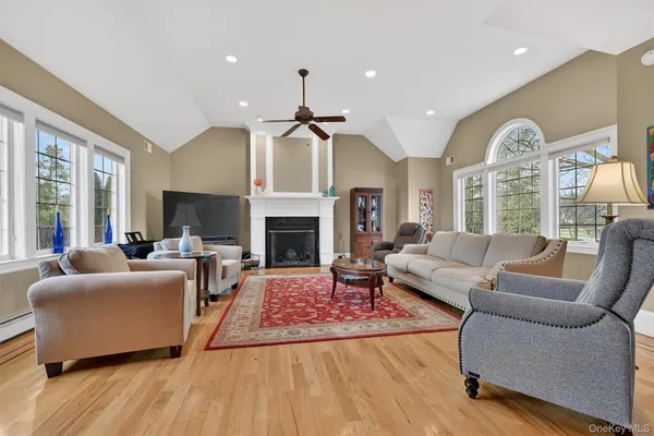 a living room with furniture fireplace and a large window