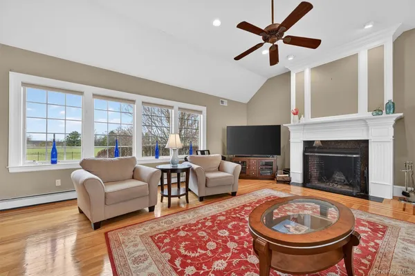 a living room with furniture a fireplace and a flat screen tv