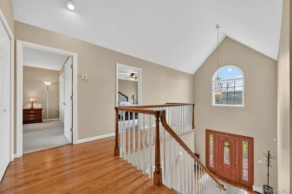 a view of a livingroom with wooden floor and stairs