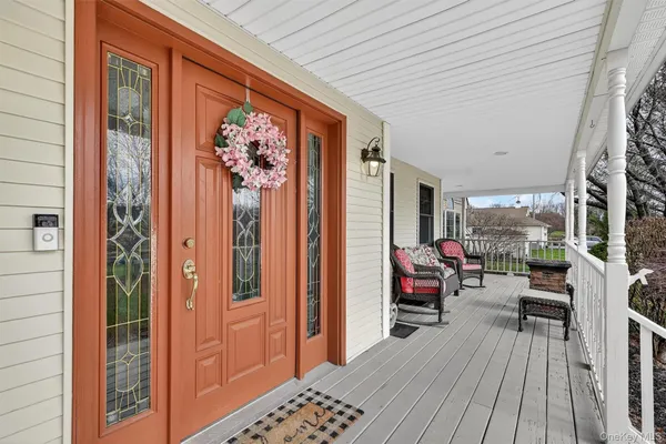 a balcony with furniture and wooden floor