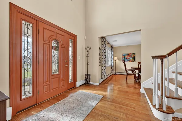 a view of a livingroom with wooden floor and furniture