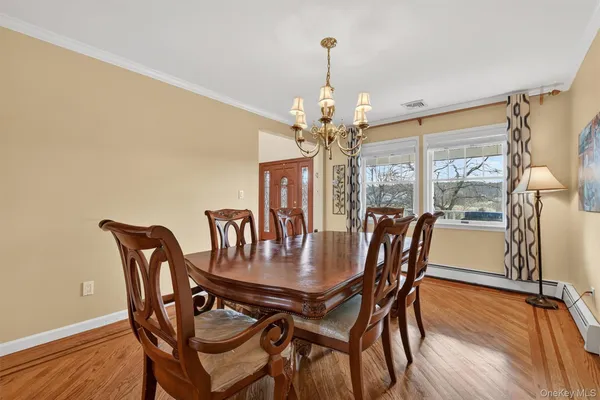 a view of a dining room with furniture wooden floor and chandelier