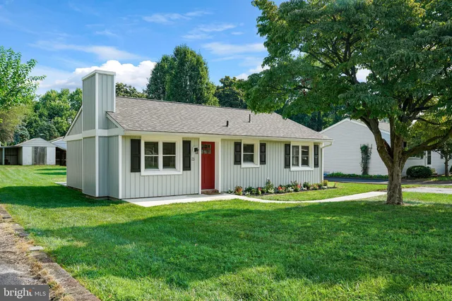 a view of a house with a yard and sitting area