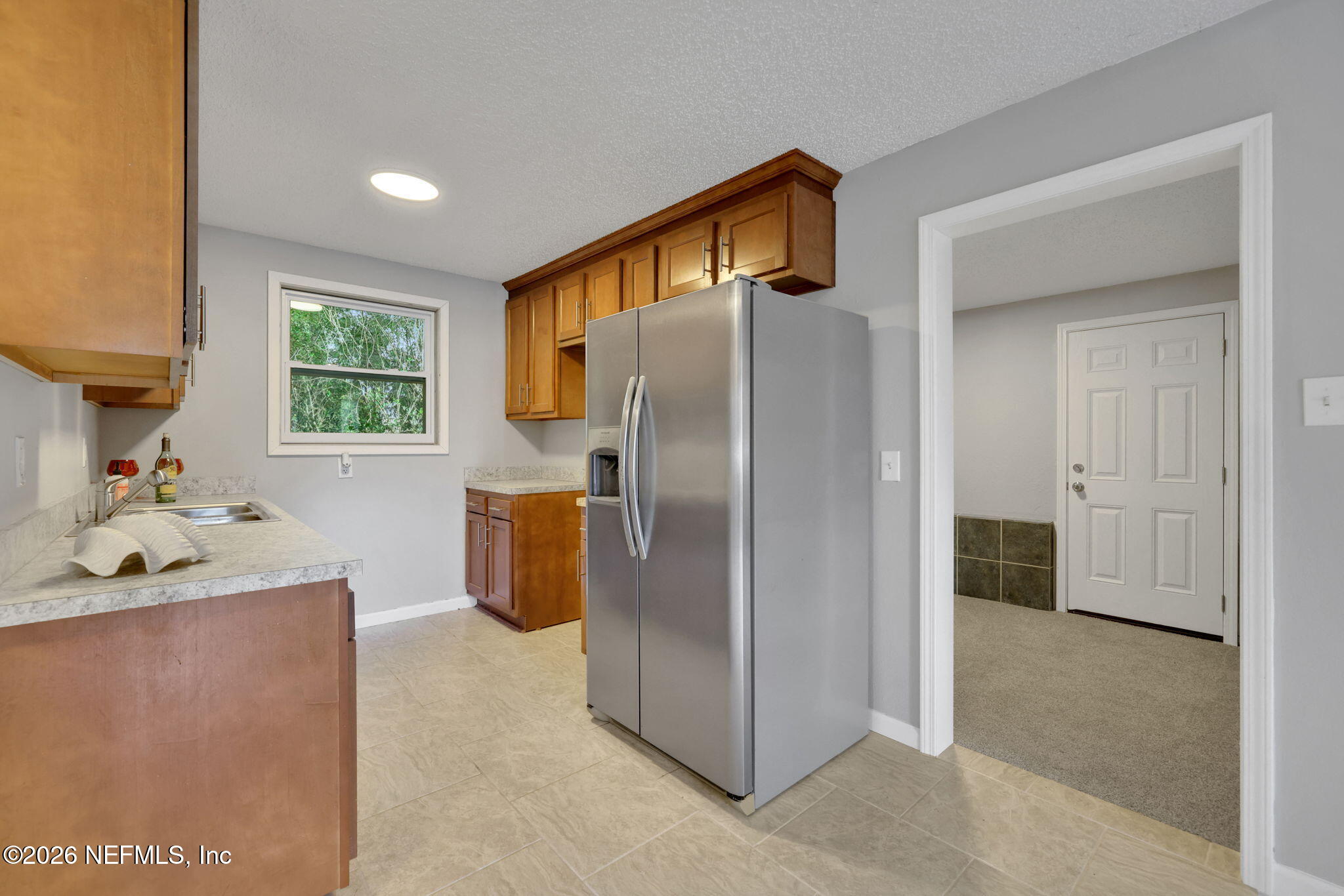 1133 Girvin Road Jacksonville, FL 32225 - Photo 16 of 69 a kitchen with stainless steel appliances granite countertop a refrigerator and a sink