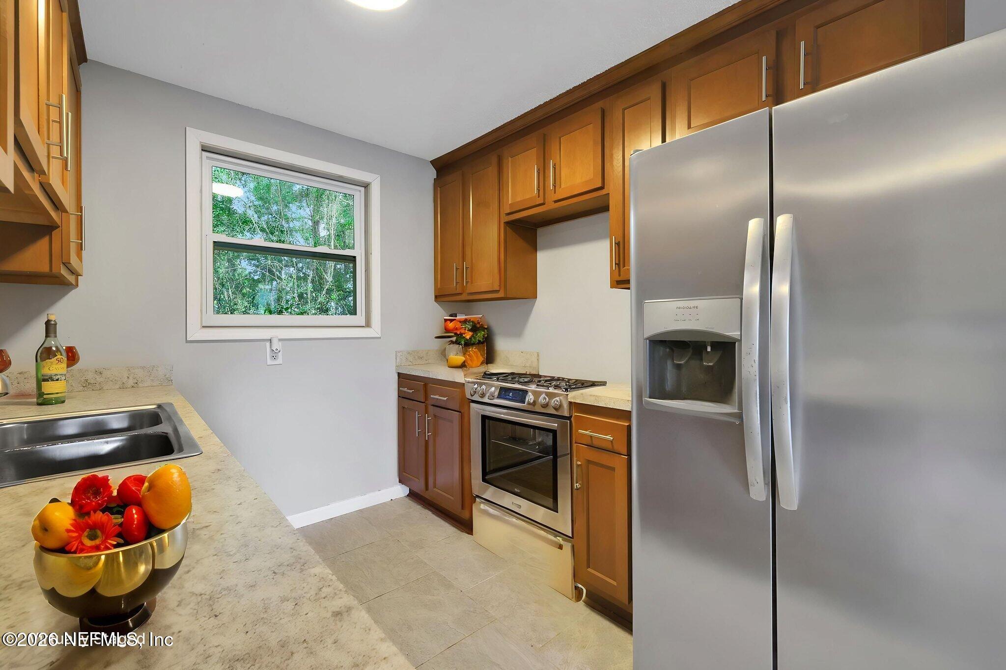 1133 Girvin Road Jacksonville, FL 32225 - Photo 17 of 69 a kitchen with stainless steel appliances granite countertop a refrigerator and a sink