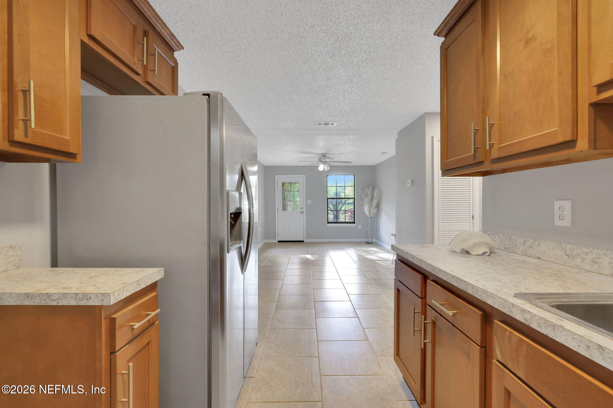 1133 Girvin Road Jacksonville, FL 32225 - Photo 19 of 69 a kitchen with stainless steel appliances granite countertop a sink and a refrigerator
