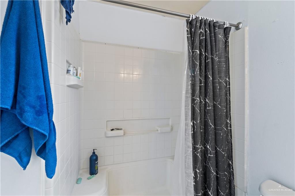 106 Rosa Priego Street Donna, TX 78537 - Photo 15 of 25 Bathroom featuring shower / bath combo and toilet