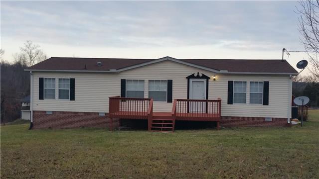 997 Hooper Road Charlotte, TN 37036 - Photo 1 of 16 Front of home. Freshly painted deck, new front door, and new shutters.