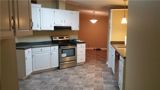 997 Hooper Road Charlotte, TN 37036 - Photo 2 of 16 Beautiful kitchen with new vinyl, fresh paint, new countertops, new stainless steel stove, and a new stainless steel dishwasher.