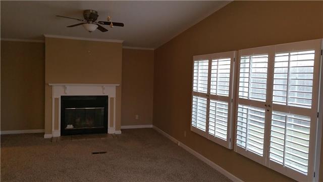 997 Hooper Road Charlotte, TN 37036 - Photo 4 of 16 Large den with fireplace, fresh paint, new carpet, new ceiling fans, and new plantation shutters.