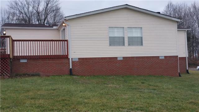 997 Hooper Road Charlotte, TN 37036 - Photo 6 of 16 Back of home. Freshly painted deck. Perfect for grilling or just hanging out and enjoying the huge back yard. Sliding doors for easy access to the den.