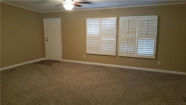 997 Hooper Road Charlotte, TN 37036 - Photo 8 of 16 Large living room with new carpet , new ceiling fan, fresh paint, and new plantation shutters