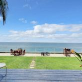a dining room with furniture and a floor to ceiling window