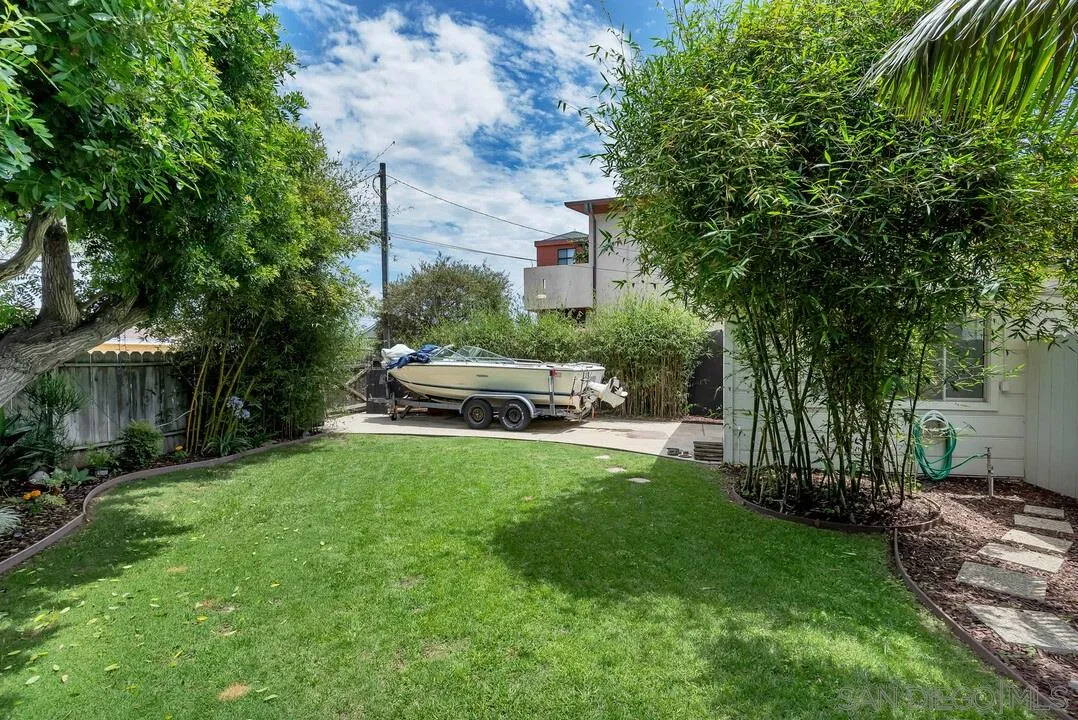 796 Neptune Avenue Encinitas, CA 92024 - Photo 11 of 49 a house with tall trees in front of it
