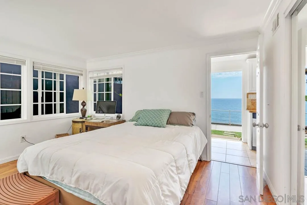796 Neptune Avenue Encinitas, CA 92024 - Photo 15 of 49 a bedroom with a bed and a large window