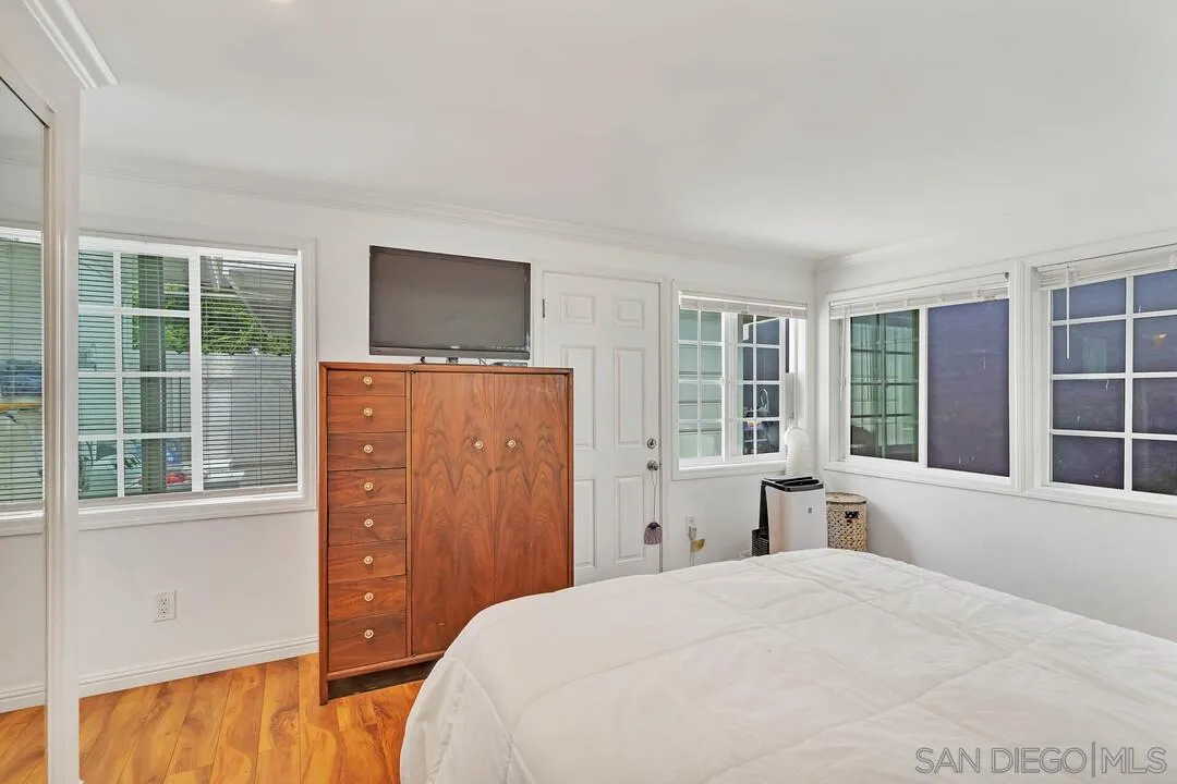796 Neptune Avenue Encinitas, CA 92024 - Photo 16 of 49 a bedroom with a bed and a large window