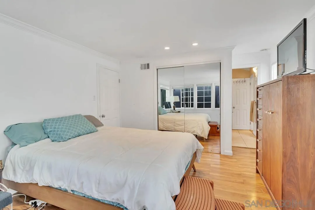 796 Neptune Avenue Encinitas, CA 92024 - Photo 17 of 49 a bedroom with a balcony a bed and a walk in closet