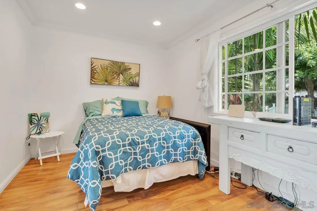 796 Neptune Avenue Encinitas, CA 92024 - Photo 21 of 49 a bedroom with a bed and a window