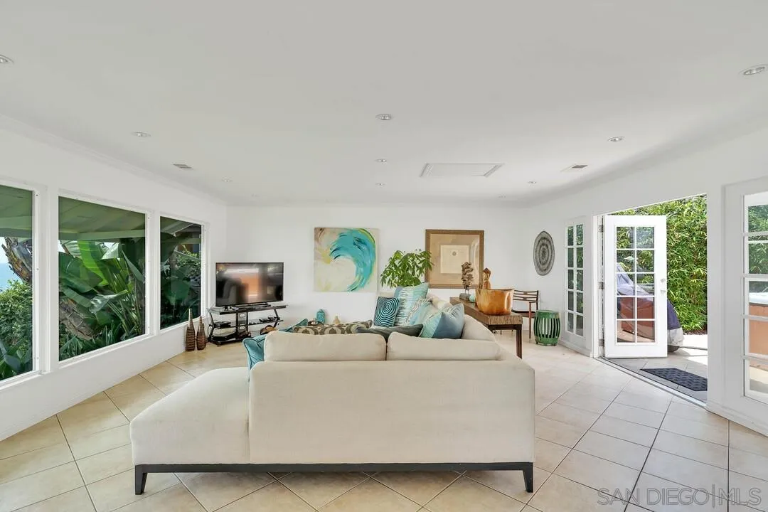 796 Neptune Avenue Encinitas, CA 92024 - Photo 25 of 49 a living room with furniture large window and flat screen tv
