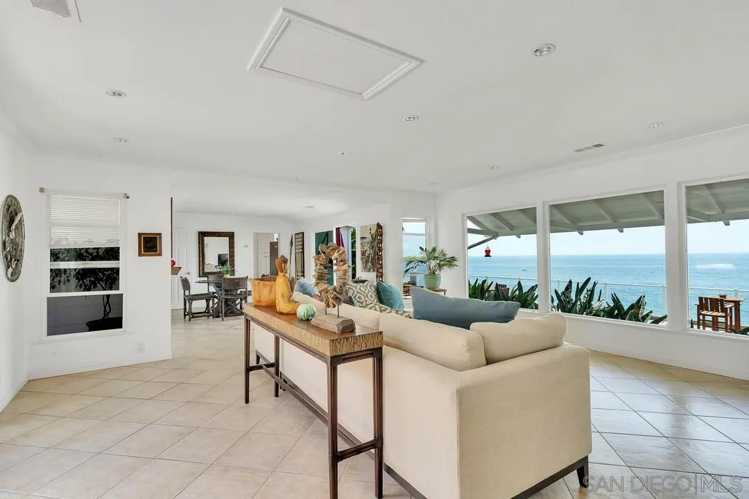 796 Neptune Avenue Encinitas, CA 92024 - Photo 27 of 49 a living room with furniture and a floor to ceiling window