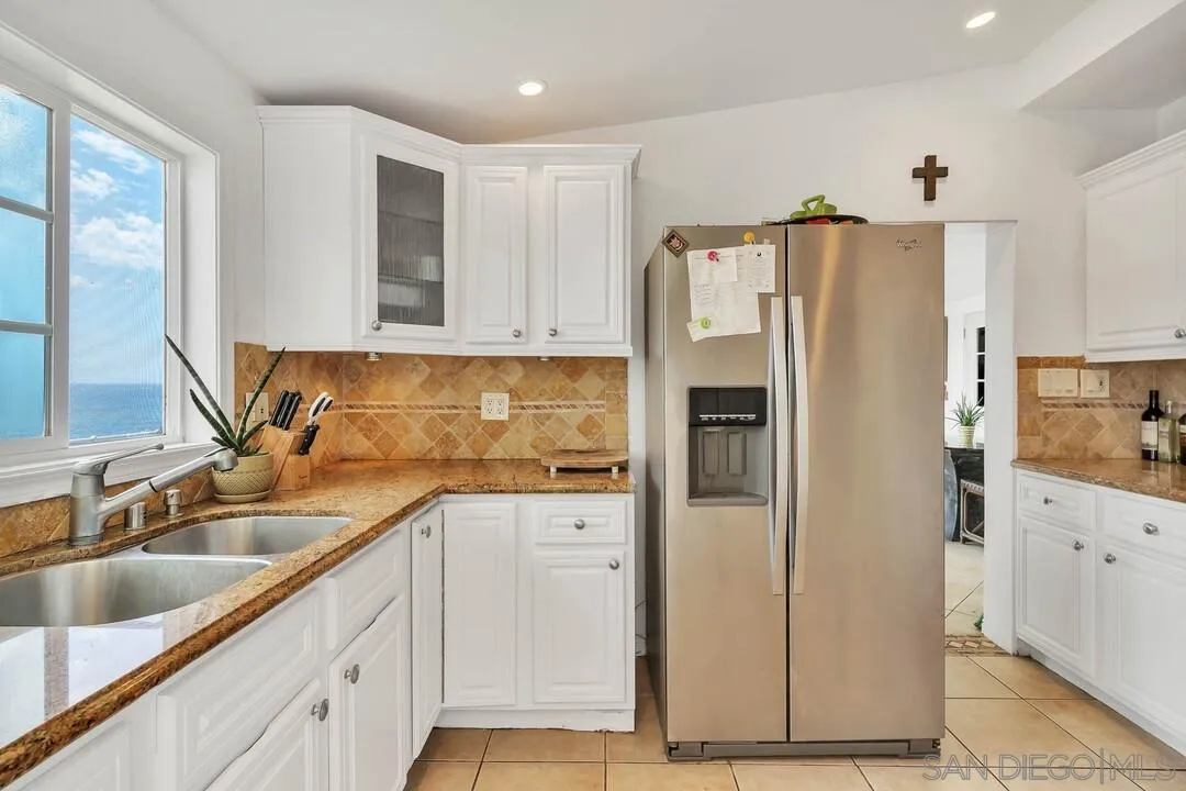 796 Neptune Avenue Encinitas, CA 92024 - Photo 31 of 49 a kitchen with stainless steel appliances granite countertop a refrigerator and a sink