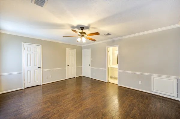 an empty room with wooden floor and window