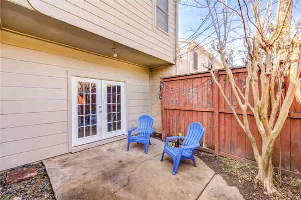 a view of a two chairs in the backyard