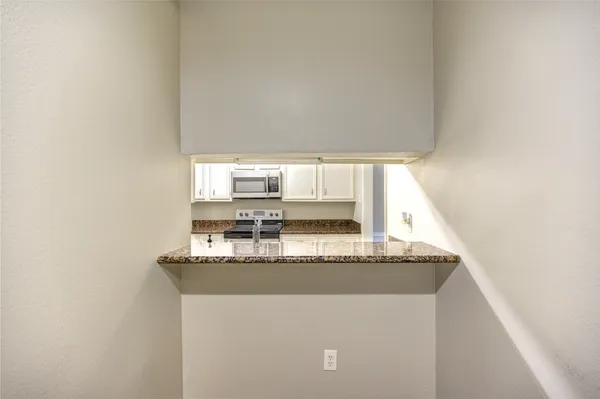 a view of a kitchen with granite countertop