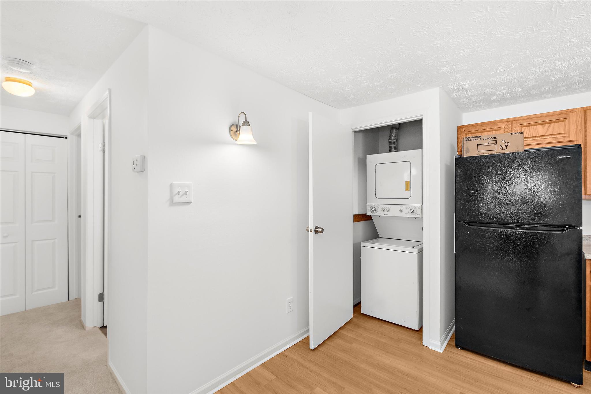 5920 Watch Chain Way, Unit 5102 Columbia, MD 21044 - Photo 12 of 29 a view of a kitchen with a refrigerator and wooden floor