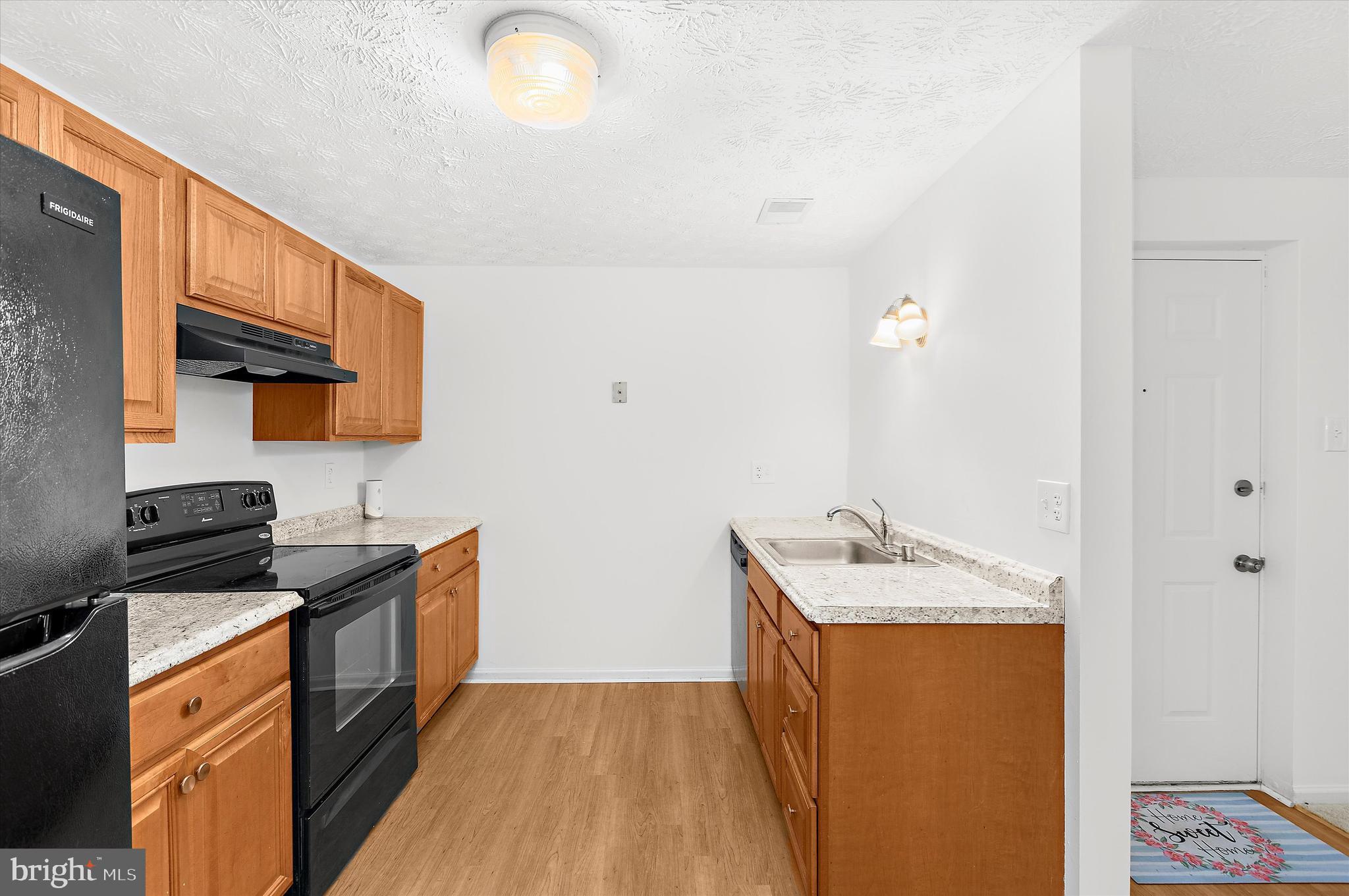 5920 Watch Chain Way, Unit 5102 Columbia, MD 21044 - Photo 13 of 29 a kitchen with stainless steel appliances granite countertop a sink stove and refrigerator