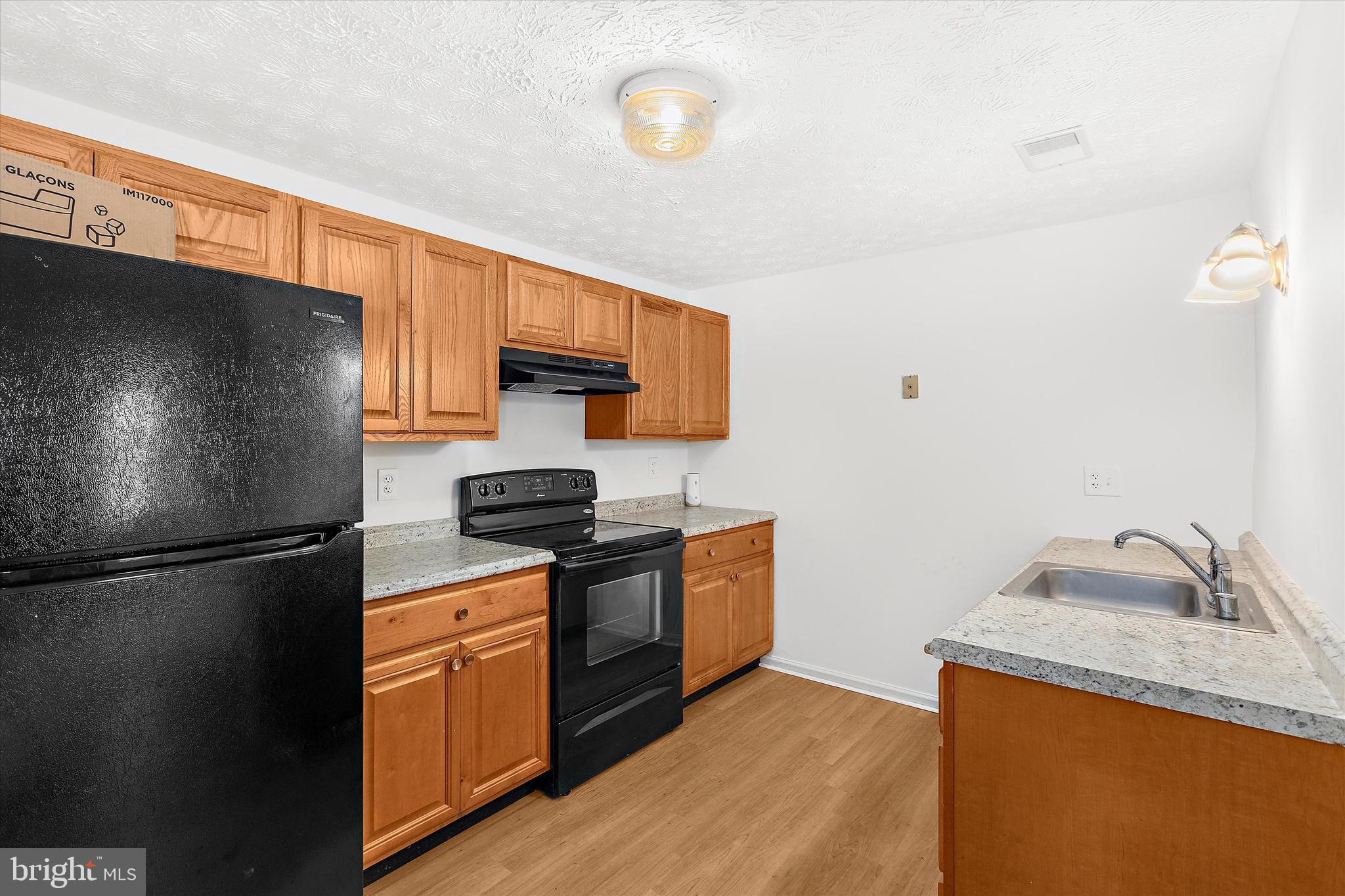 5920 Watch Chain Way, Unit 5102 Columbia, MD 21044 - Photo 16 of 29 a kitchen with stainless steel appliances granite countertop a refrigerator a stove a sink and a microwave